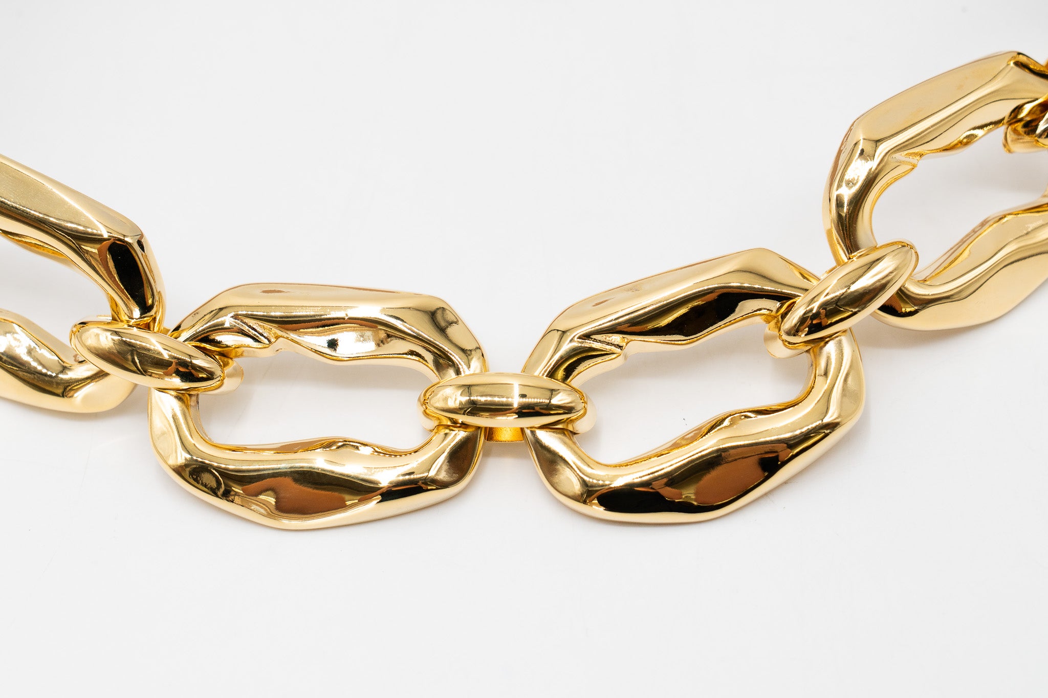 Streets Ahead Calla Belt — black patent leather with gold chain-link hardware