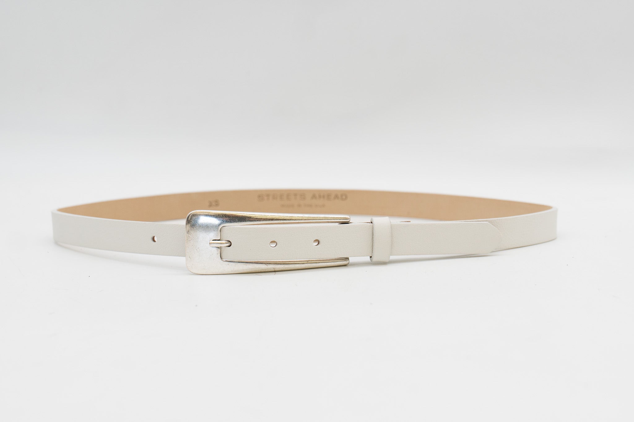 White Italian leather belt with silver buckle, handcrafted in Los Angeles using custom hardware
