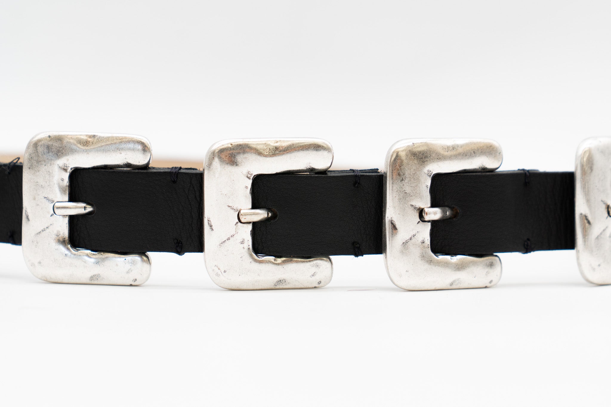 Black Italian leather belt with sculptural silver-plated multi-buckle detailing, handcrafted in Los Angeles using custom hardware