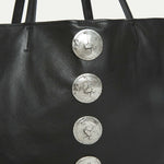 Close-up of silver Italian hardware detail on the Gaia Slouchy Tote in black leather.