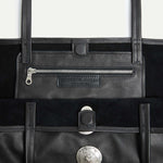 Interior detail of the Gaia Slouchy Tote in black Italian leather with zip pocket and magnetic closure.