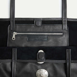 Interior detail of the Gaia Slouchy Tote in black Italian leather with zip pocket and magnetic closure.
