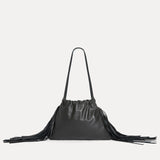Front view of the Diana Fringe Bag in black leather with drawstring closure and side fringe - Streets Ahead