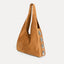 Angled view of the Rhea Slouchy Hobo in tan suede showing slouchy silhouette and silver side detail - Streets Ahead