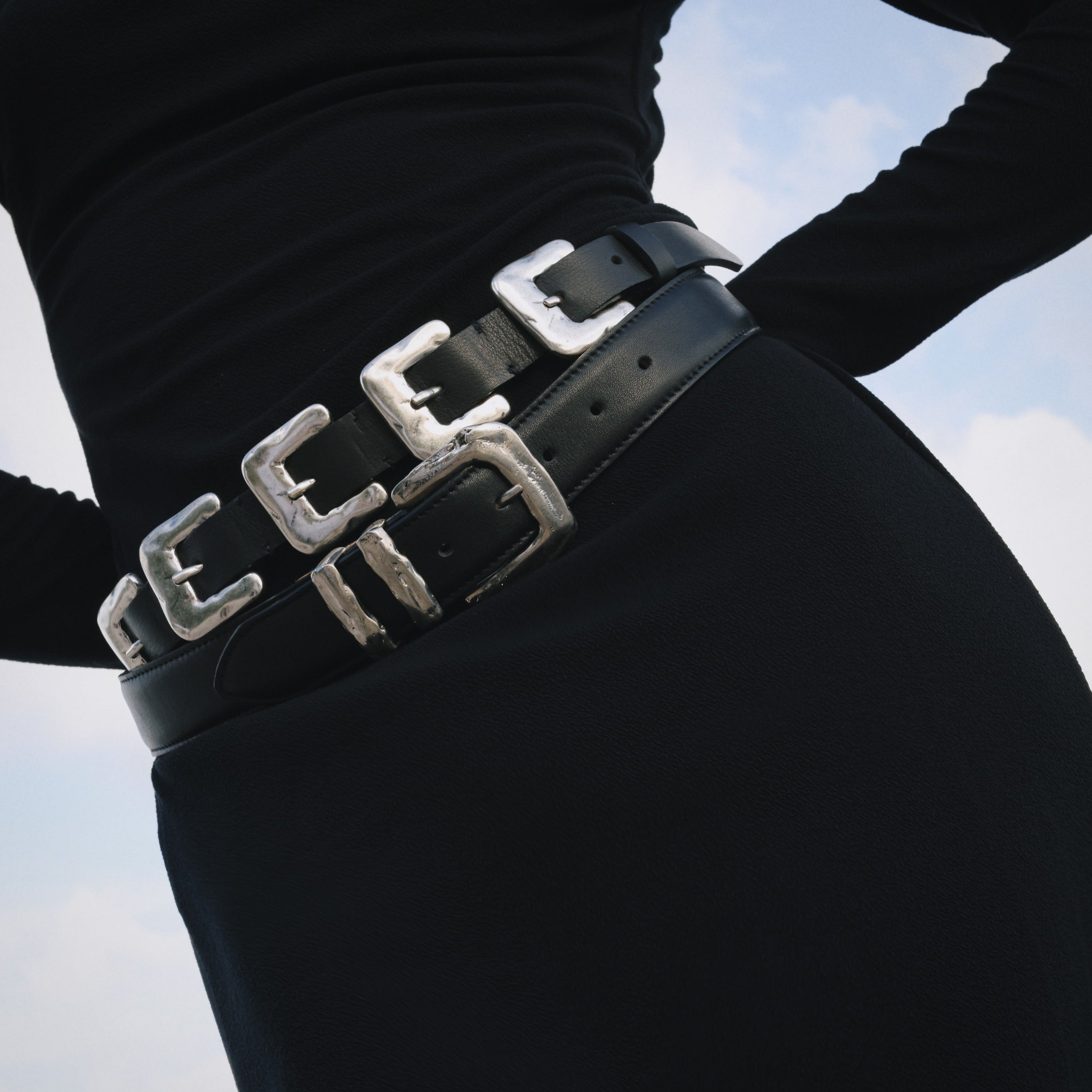 Black Italian leather belt with sculptural silver-plated multi-buckle detailing, handcrafted in Los Angeles using custom hardware