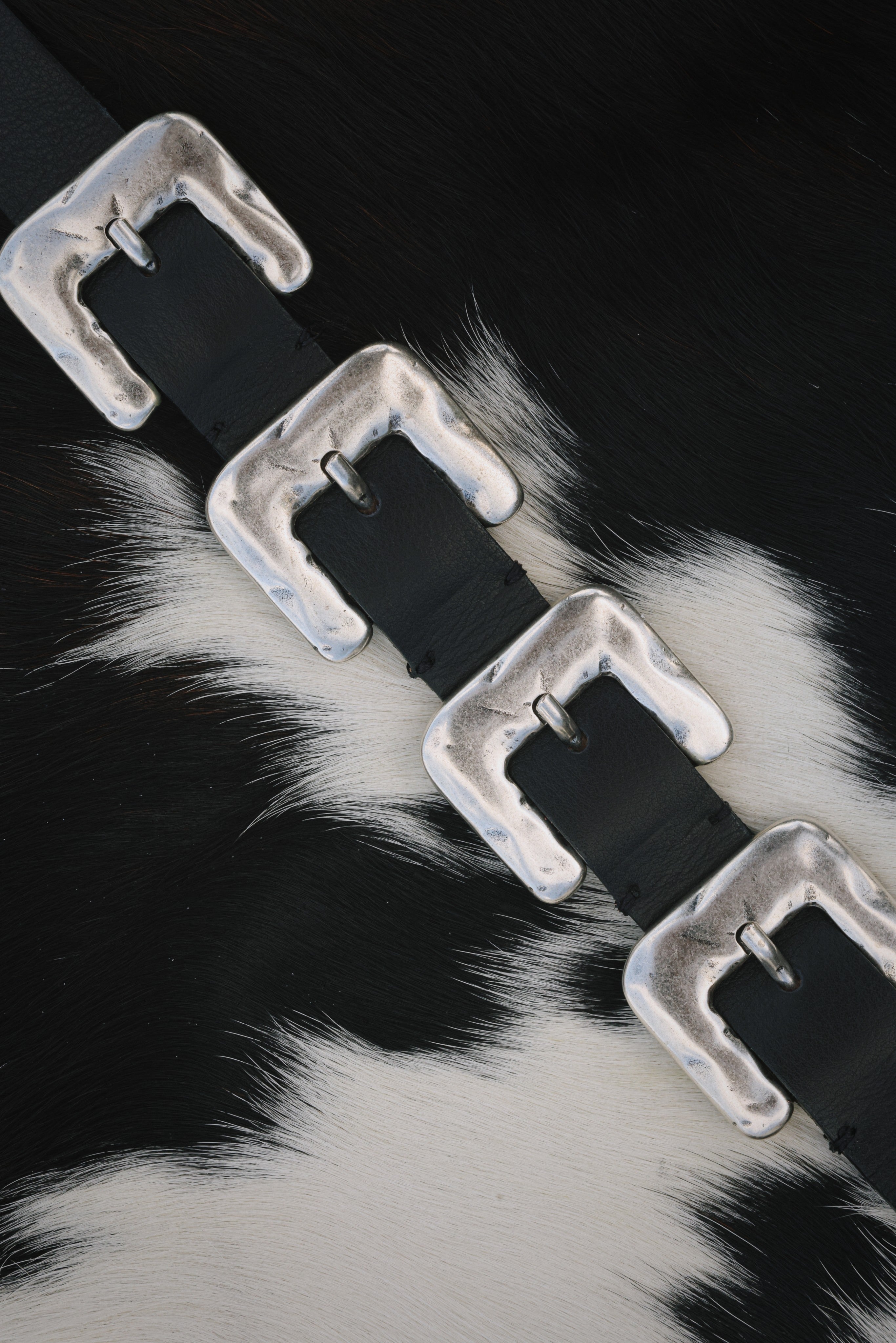 Black Italian leather belt with sculptural silver-plated multi-buckle detailing, handcrafted in Los Angeles using custom hardware