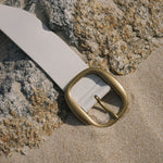 White Italian leather belt with brass-plated buckle, handcrafted in Los Angeles using custom hardware