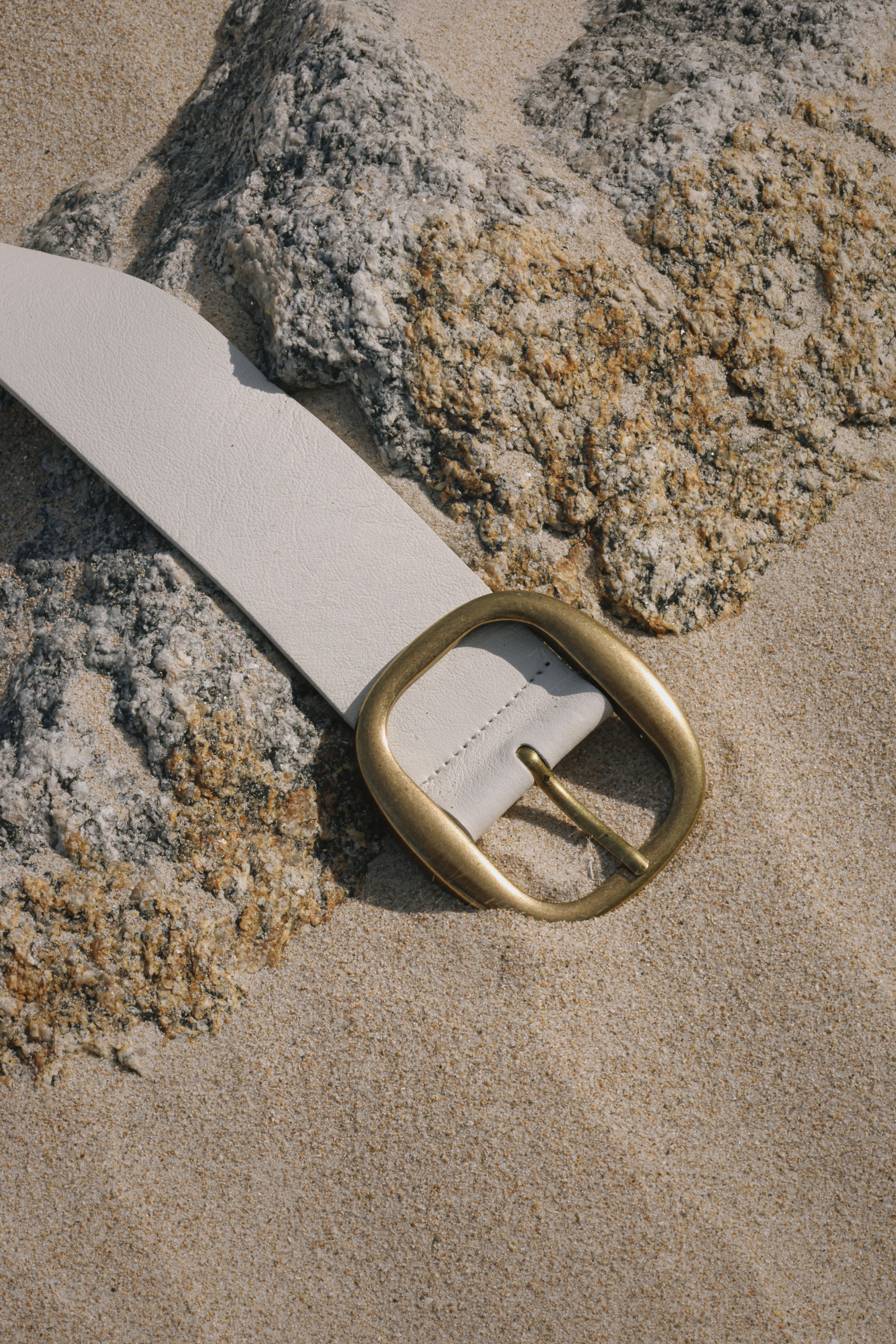 White Italian leather belt with brass-plated buckle, handcrafted in Los Angeles using custom hardware